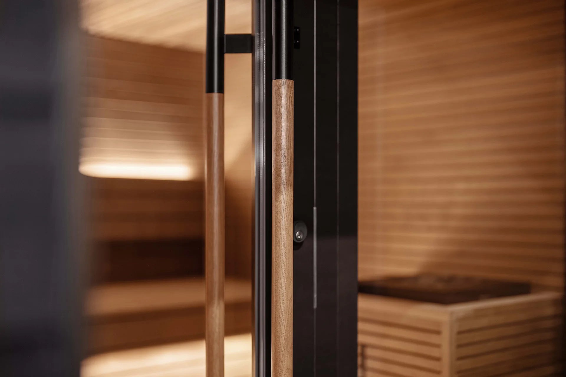 Stylishly designed outdoor sauna with all-glass doors for a luxurious family spa experience