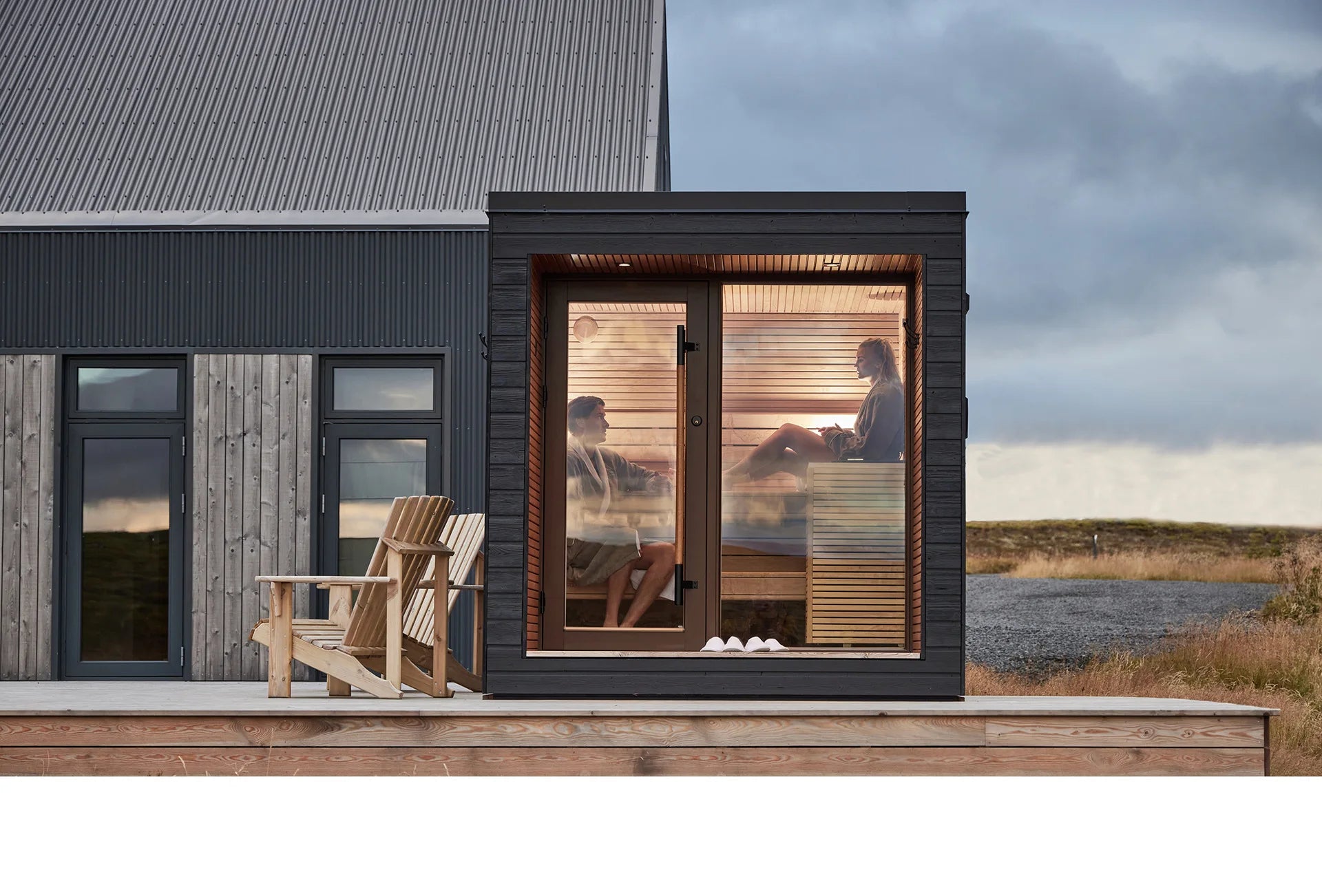 Stylishly designed outdoor sauna with all-glass doors for a luxurious family spa experience